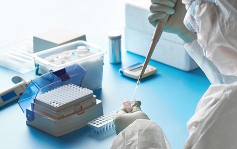 Sars Cov 2 Pcr Diagnostics Kit. Epidemiologist In Protective Suit, Mask And Glasses Works With Patient Swabs To Detect Specific Region Of 2019 Ncov Virus Causing Covid 19 Viral Pneumonia.