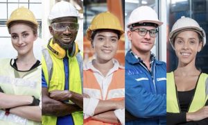 Group Of Manual Workers Engineering Standing With Confident At Work Place. Concept Of Smart Industry Worker Operating. Diversity Of People Of Men And Women Of Asian, Caucasian, African.