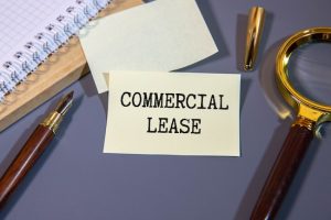 Commercial Lease Text Concept Write On A Notebook On Wooden Background.
