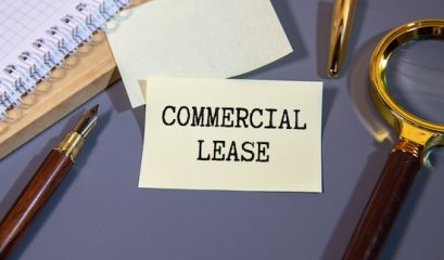 Commercial Lease Text Concept Write On A Notebook On Wooden Background.